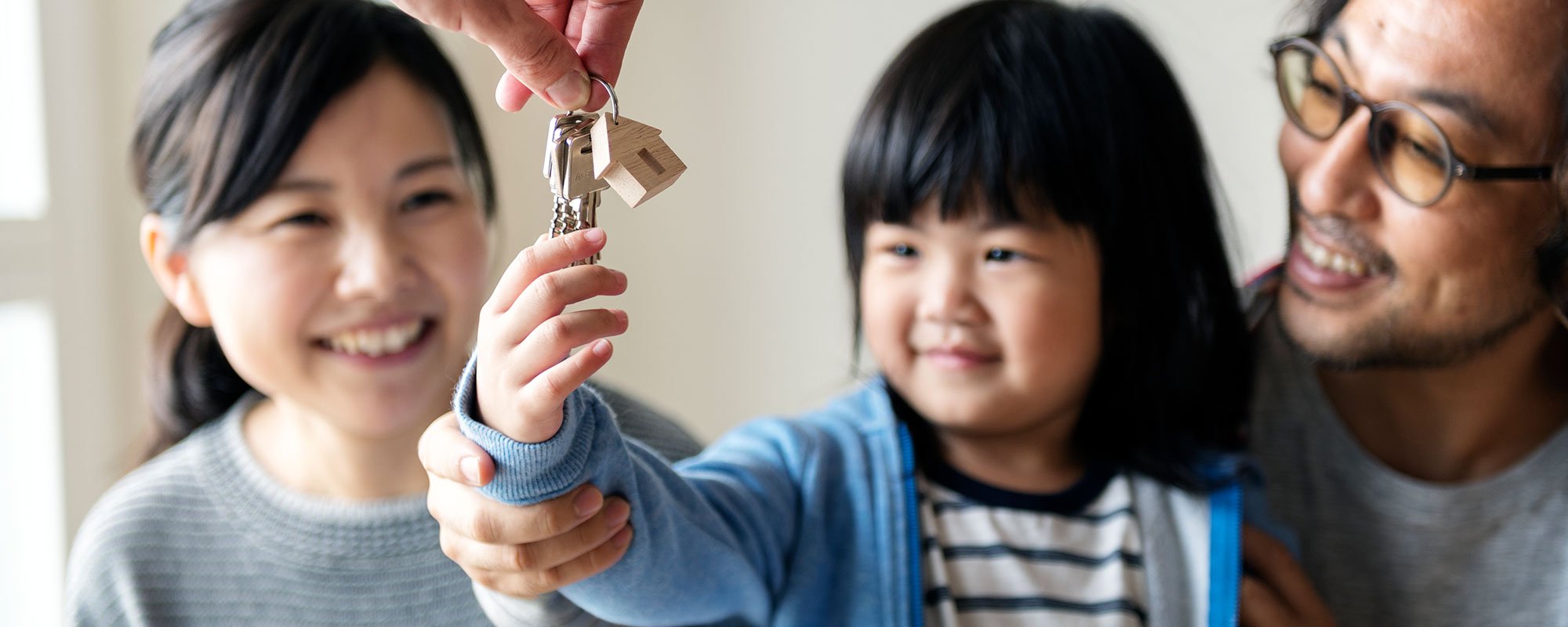 Child and family with new home keys